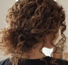 the back of a woman's head with curly hair