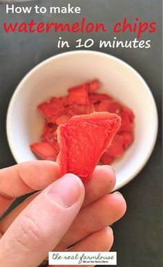 someone holding up a piece of watermelon in front of a white bowl with the words how to make watermelon chips in 10 minutes