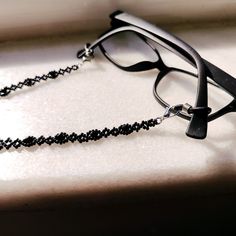 This handmade black crystal glasses chain is made from the highest quality glass beads, carefully hand-woven! It is not only a glasses chain, but also a multi-purpose chain that you can use as a stylish necklace wrap bracelet and goth style sunglasses chain! It is light! This way, your glasses will never be lost! Lenght 70 cm ( 27 inches ) Shiny glasses chain, compatible with all your clothes that you can use in all seasons, is the ideal handmade gift accessory and jewelry for you and your loved Black Metal Glasses Chains With Adjustable Chain, Black Metal Glasses Chain With Adjustable Feature, Black Metal Glasses Chain With Adjustable Length, Black Metal Adjustable Glasses Chain, Black Adjustable Glasses Chain For Parties, Black Glass Beaded Jewelry, Adjustable Black Metal Glasses Chains, Elegant Black Metal Glasses Chains, Beaded Metal Glasses Chains As Gift