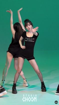 two women in black dresses are dancing on a green background with the words studio mode