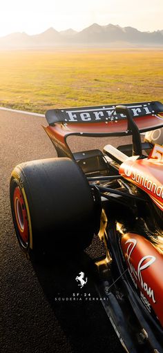 a red and black race car driving down the road