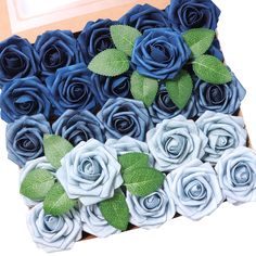 a box filled with blue and white roses