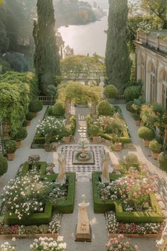 the formal garden is full of flowers and greenery