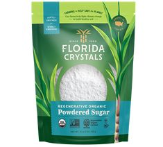 a bag of powdered sugar with green grass in the front and on the side