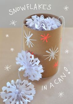 some paper snowflakes are in a cup