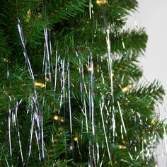 a close up of a christmas tree with tinsel