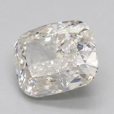 a cushion cut diamond on a white surface