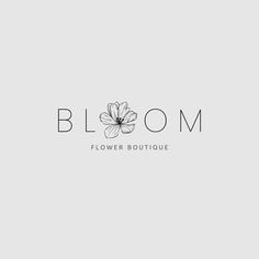 a flower boutique logo on a gray background with the word bloom above it and a white flower