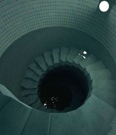 a spiral staircase in the middle of a tiled floor