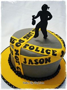 a cake with a woman holding a baseball bat on top of the cake is decorated in black and yellow