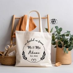 a personalized tote bag sitting on top of a wooden chair next to a potted plant