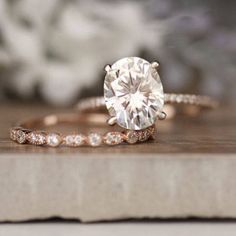 a close up of a ring with a diamond in it on top of a book