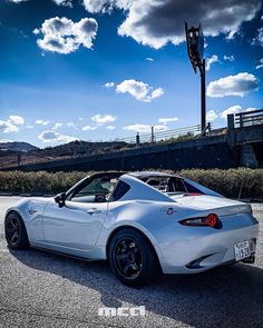 a white sports car parked on the street