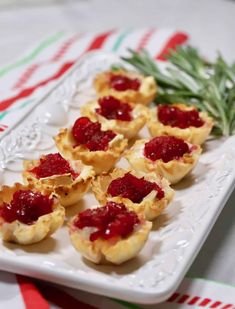 small appetizers are arranged on a white plate and ready to be eaten at a party