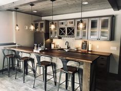 a kitchen with an island and bar stools