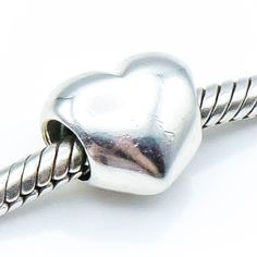 "Authentic PANDORA Sterling Silver Heart Charm, 925 ALE, Retired. Say \"I love you\" with this simple but elegant heart. It matches any bracelet design and reminds her of you. This item is retired from production and may be difficult to find. Charm is pre-owned and in great condition. This beautiful bead will add a special touch to your bracelet creation. The charm shown in the pictures is the one you will receive. Feel free to message me with any questions. Fast shipping and handling from Birmi Classic Gold Heart Charm Bracelet, Classic Gold Bracelet With Heart Charm, Everyday Silver Heart Charm Bracelet, Silver Heart Bracelet For Everyday Wear, Valentine's Day Heart Bracelet With Sterling Silver Clasp, Everyday White Gold Heart Bracelet, Pandora Heart, Murano Glass Beads, Pandora Silver