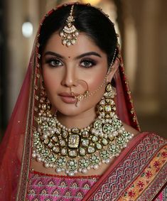 a woman wearing a bridal outfit and jewelry