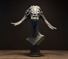 a sculpture of a bull's head with horns on top of a wooden table