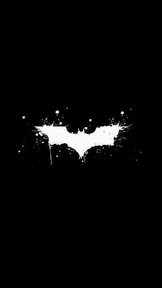 the dark knight rises logo on a black background with white paint splattered over it