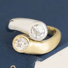 A beautiful pair of old European cut diamonds were begging to be kept together so we created this vintage-leaning bypass setting in both platinum and yellow gold. The look is one that is definitely statement-making - and we simply adore it! Its the perfect "you and me" are the same yet different. Platinum & 18kt yellow gold Size 5.75 & resizable Diamonds Measure: 5.23 - 5.45 x 3.05 mm & 4.88 - 5.14 x 3.54 mm GIA Report Here & Here Video Below Classic Round Bypass Ring With Tension Setting, Timeless Bypass Ring With Round Cut For Anniversary, Classic White Gold Bypass Ring With Tension Setting, Vintage Round Cut Diamond Ring With Tension Setting, Classic Yellow Gold Bypass Ring With Tension Setting, Gold Timeless Bypass Ring For Anniversary, Timeless Gold Bypass Ring For Anniversary, Timeless White Gold Bypass Ring For Anniversary, Timeless Brilliant Cut Bypass Ring For Anniversary