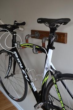 two bikes are parked next to each other in a room with wood floors and white walls