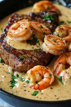 steak and shrimp with sauce in a skillet