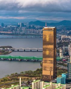 an aerial view of a large city and the water in front of some tall buildings