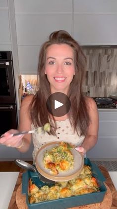 a woman holding a plate with food in it