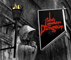 a black and white photo of a sign that says the london dungeon on it's side