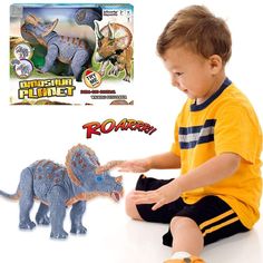 a young boy playing with a toy dinosaur