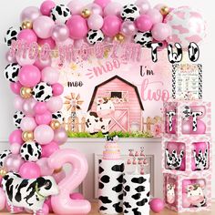 a pink and black cow themed birthday party with balloons, streamers, decorations, and decor