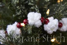 some cotton balls are hanging from a christmas tree