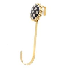 a black and white checkerboard umbrella hook on a gold plated metal stand