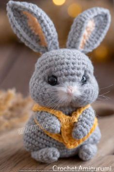 a crocheted bunny sitting on top of a wooden table