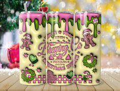 three pink and green candles with designs on them