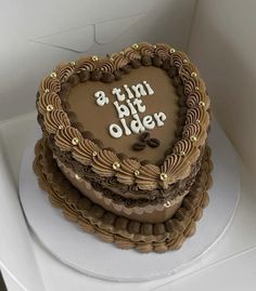 a heart shaped chocolate cake with the words 8 th birthday older on it's side