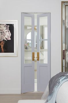 the interior of a bedroom with double doors