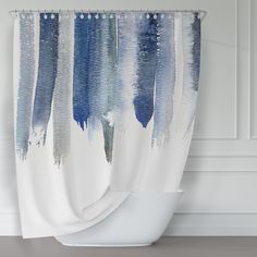 a blue and white shower curtain hanging on a wall