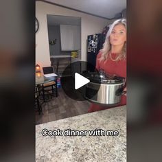 a woman is holding an electric pressure cooker in her kitchen with the words cook dinner with me on it