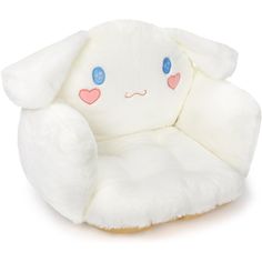 a white stuffed animal chair with blue eyes