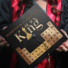 a woman holding a black and gold graduation cap with the words, elements of an entiched block on it