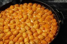 a pan filled with tater tots sitting on top of a table