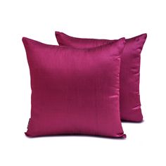 two pink pillows sitting next to each other