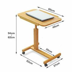 a wooden table with a laptop on it and measurements for the height of the table