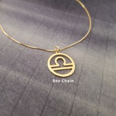 a gold necklace with the word box chain written in cursive font on it