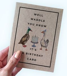 a hand holding up a card with ducks and a cake on it that says, well waddle you know it's a birthday card