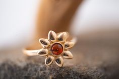 Cordis Art presents elegant amber ring. Unique piece of cognac amber fitted in sterling silver and covered by 14ct gold layer. Contemporary flower ring. Perfect for evening dress and for every day.  Size of design: length 13mm, width 13mm. Size of stone: length 4mm, width 4mm. Size of the ring is udjustable: from US 7 to US 9. This ring comes with lifetime craftwork warranty for your peace of mind. Gift wrap is also provided.  Cordis means heart. Cordis Art is the place where you can find jewell Amber Ring, Contemporary Ring, Elegant Ring, Flower Ring, Multi Stone, Multi Stone Ring, Cognac, Stone Rings, Amber