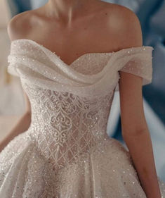 a woman in a white wedding dress is posing for the camera with her hand on her hip