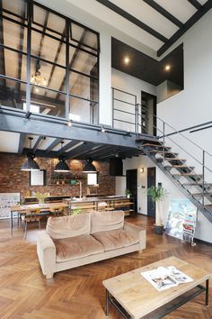 a living room filled with furniture and a stair case