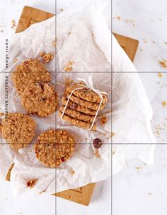 four cookies on top of a piece of paper next to a box of granola